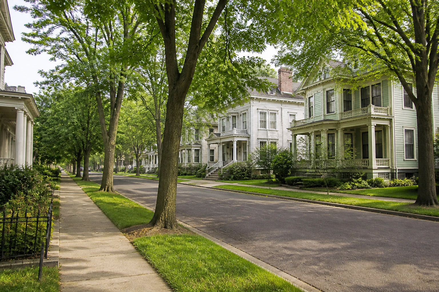 Tree-lined residential street in central Oswego with classic Victorian homes near the hospital district